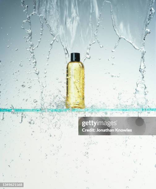 water falling over bottle - shampoo bottle white background stock pictures, royalty-free photos & images