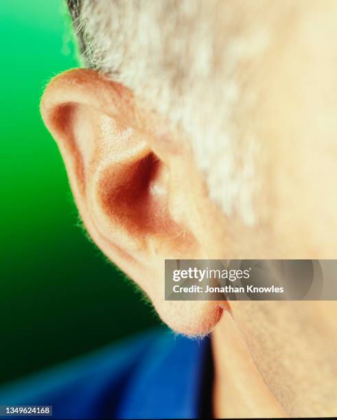 close up male ear - human ear close up stock pictures, royalty-free photos & images