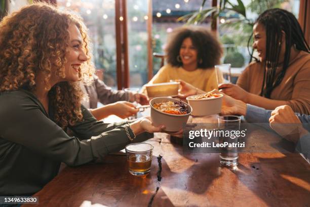 group of young friends catching up for dining together at home - alcohol free stock pictures, royalty-free photos & images