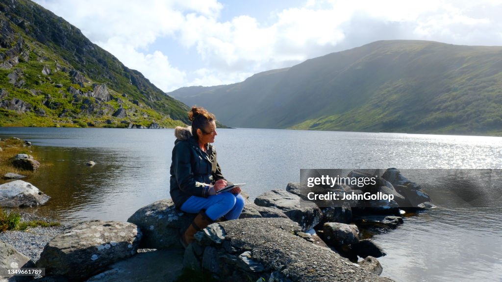 Woman Sketching by Lake