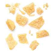 Pieces of parmesan cheese isolated on white background. Pattern. Parmesan  top view. Flat lay.