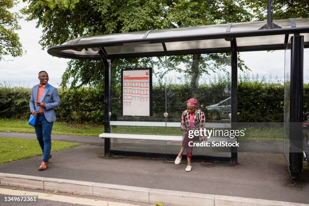 waiting for a bus - bus stop uk stock pictures, royalty-free photos & images