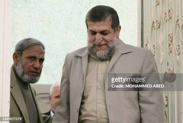 Senior member of the Radical Islamic Jihad movement Nafez Azam walks out with Hamas leader and MP Mahmud al-Zahar following their meeting in Gaza...
