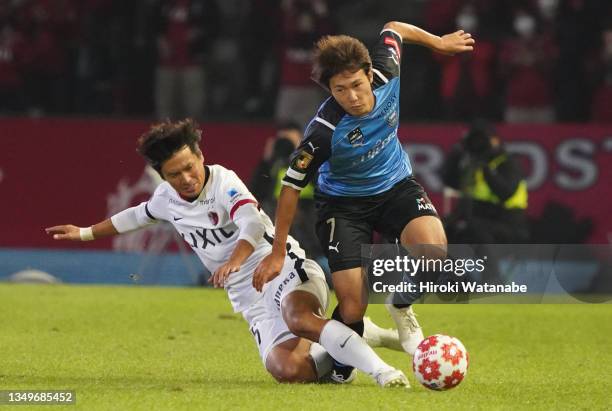 Yasushi Endo of Kashima Antlers and Shintaro Kurumaya of Kawasaki Frontale compete for the ball during the 101st Emperor's Cup quarter final between...