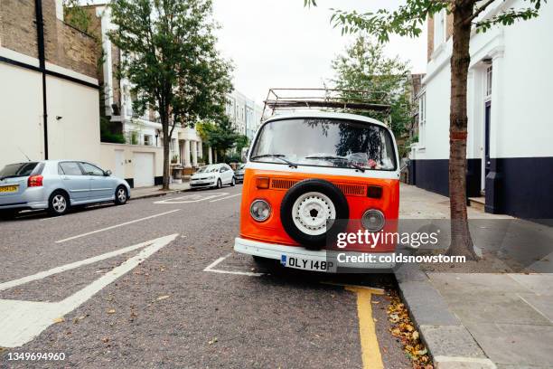 vintage volkswagen camper van parked on city street - vw van stock pictures, royalty-free photos & images