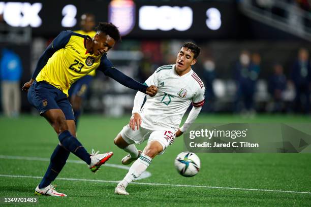 Joshue Quinones of Ecuador attempts to clear the ball from Alejandro Zendejas of Mexico during the second half of their match at Bank of America...