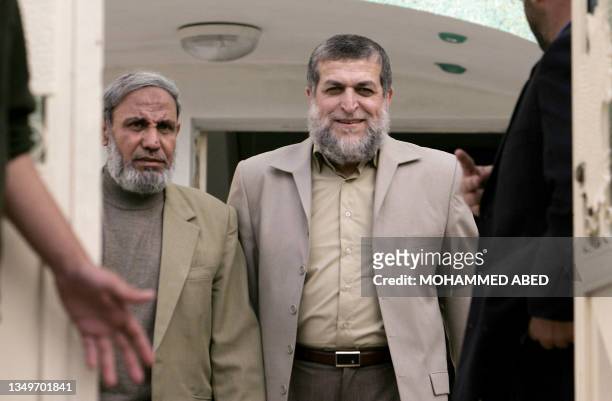 Senior member of the Radical Islamic Jihad movement Nafez Azam walks out with Hamas leader and MP Mahmud al-Zahar following their meeting in Gaza...