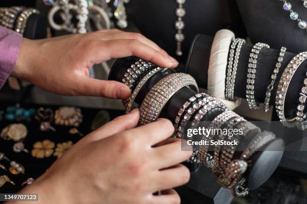 looking at vintage jewellery - jewellery products stock pictures, royalty-free photos & images
