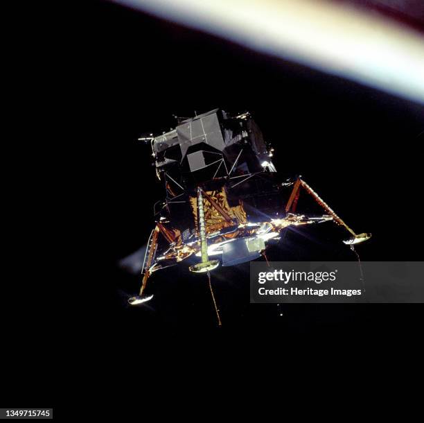 Eagle In Lunar Orbit, 1969. The Apollo 11 Lunar Module "Eagle", in a landing configuration is photographed in lunar orbit from the Command and...