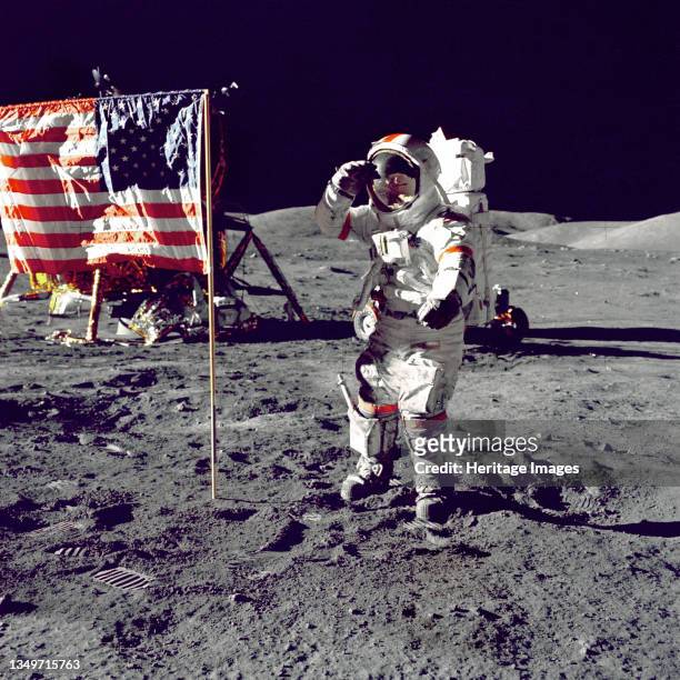 Cernan Jump Salutes Flag, 1972. Eugene A. Cernan, Commander, Apollo 17, salutes the US flag on the lunar surface during extravehicular activity on...