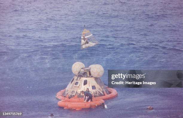 Apollo 13 Recovery Area, 1970. Astronaut John L. Swigert Jr., command module pilot, is lifted aboard a helicopter in a Billy Pugh helicopter rescue...