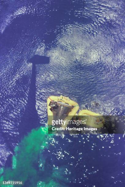 Gemini 4 Recovery with Green Marker Dye, 1965. Overhead view of the Gemini 4 spacecraft showing the yellow flotation collar used to stabilize the...