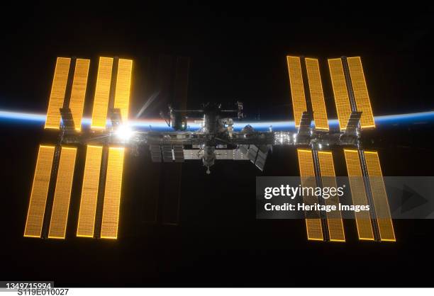 International Space Station, March 2009. Backlit view of the ISS with solar array. Artist .