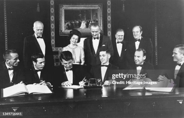 Apollo 7 and 8 Crew in the White House, 1968. Apollo 7 and 8 flight crews sign a commemorative document to be hung in the Treaty Room of the White...