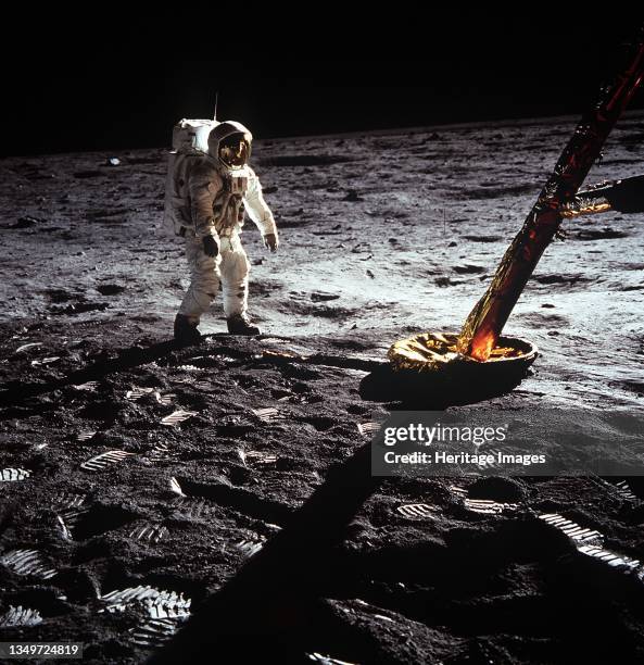 Buzz Aldrin by the leg of the Lunar Module, Apollo II mission, July 1969. Astronaut Buzz Aldrin walking on the lunar surface, by the footpad of the...