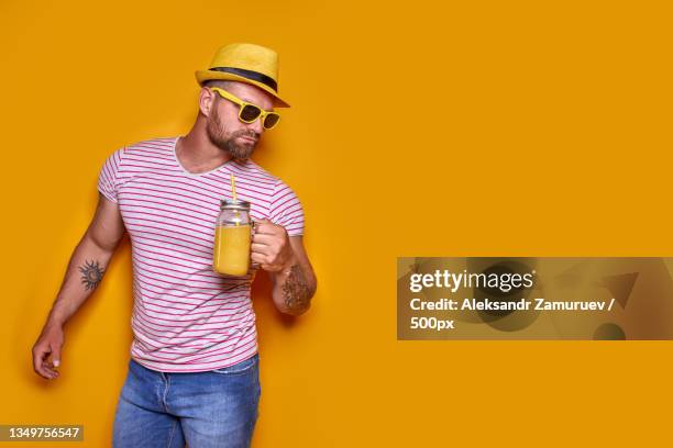 creative male in sunglasses and summer clothes,stylish hat standing - blue white summer hat background stock pictures, royalty-free photos & images