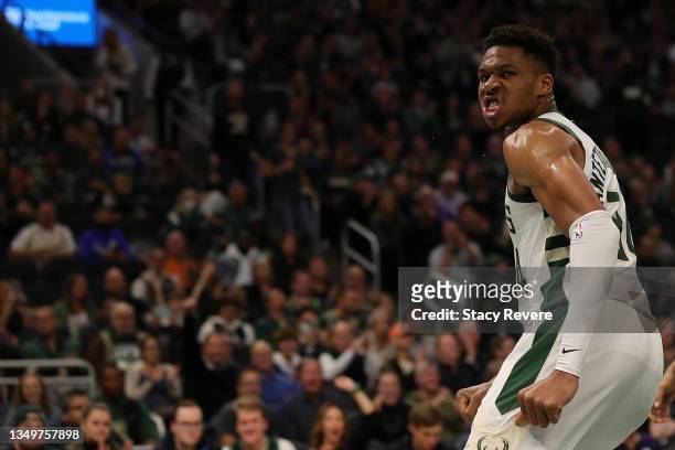 Giannis Antetokounmpo of the Milwaukee Bucks reacts to a dunk during the first half of a game against the Minnesota Timberwolves at Fiserv Forum on...