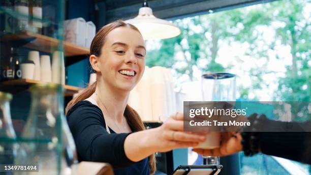 woman serving coffee to customer - inside coffe store stock pictures, royalty-free photos & images