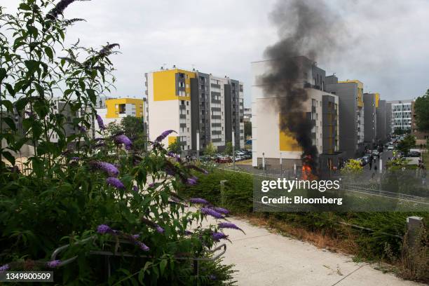 Fire set by demonstrators near apartment buildings following a march protesting the shooting of Nahel by a police officer in the Nanterre suburb of...