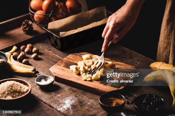 close-up of a woman baking banana bread in the kitchen - banana stock pictures, royalty-free photos & images