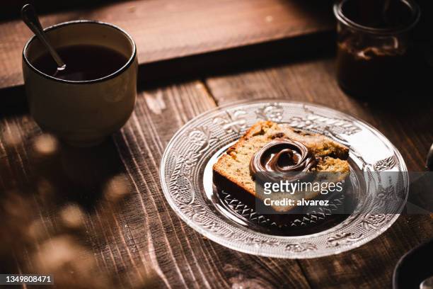 banana bread with chocolate spread and black tea on breakfast table - spread over stock pictures, royalty-free photos & images