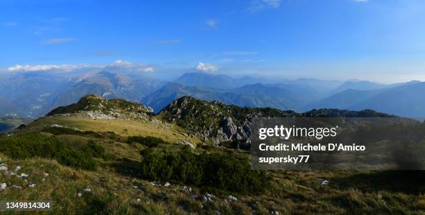 hiking on a karst plateau in the alps - roccia carsica foto e immagini stock