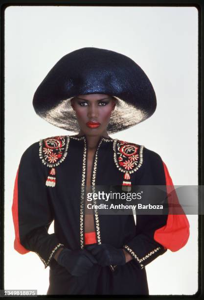 Portrait of Jamaican-born model, singer, and actress Grace Jones as she wears a black hat and multi-colored top, New York, New York, late twentieth...
