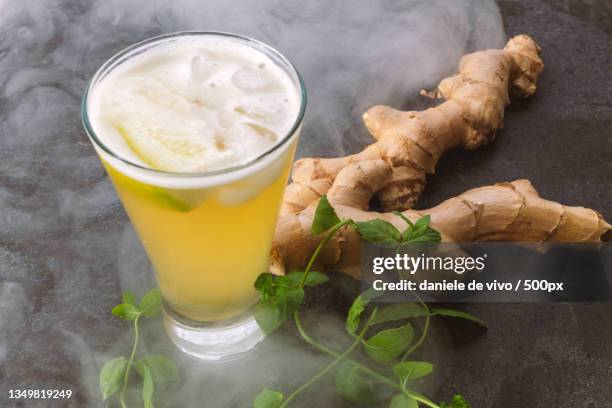 Closeup Of Drink With Ginger And Leaves On Table High-Res Stock Photo