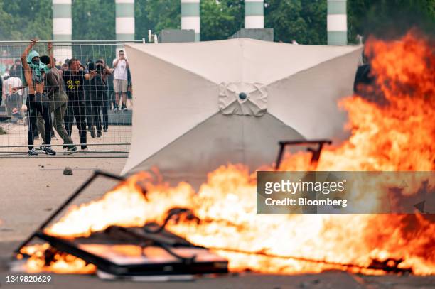 Demonstrators set fire to street furniture following a march protesting the shooting of Nahel by a police officer in the Nanterre suburb of Paris,...