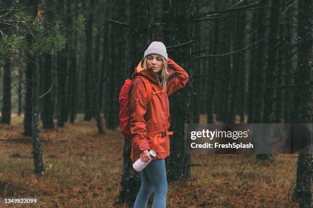 young female hiker in sportswear standing in the forest - eastern european stock pictures, royalty-free photos & images