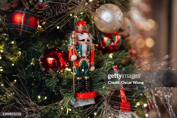 close-up of christmas ornaments hanging on christmas tree - christmas tree close up stock pictures, royalty-free photos & images