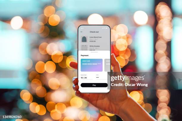 doing christmas shopping online with smart phone - online payment stock pictures, royalty-free photos & images