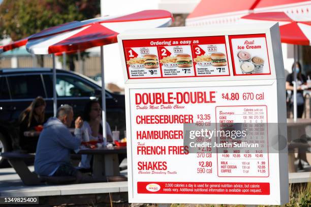 Menu is displayed in the drive thru at an In-n-Out restaurant on October 28, 2021 in Pleasant Hill, California. Contra Costa county health officials...