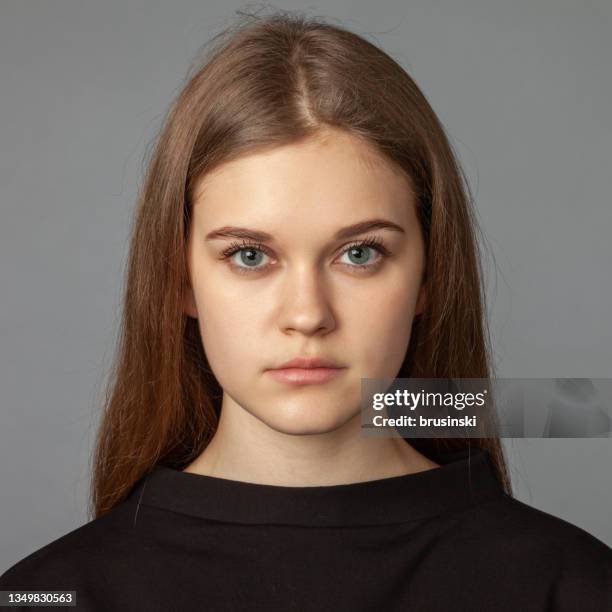close up studio portrait of attractive 19 year old woman with brown hair on gray background - year long stock pictures, royalty-free photos & images