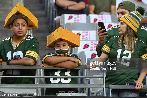 Fans of the Green Bay Packers watch action prior to a game against the Arizona Cardinals at State Farm Stadium on October 28, 2021 in Glendale,...