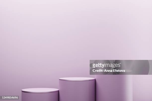 three purple cylindrical podiums on pastel purple background. perfect platform for showing your products. three dimensional illustration - podio del vincitore foto e immagini stock