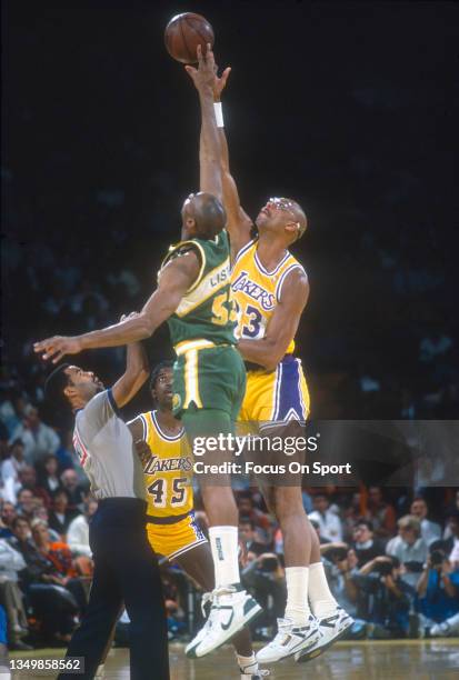 Kareem Abdul-Jabbar of the Los Angeles Lakers battles for the tip-off with Alton Lister of the Seattle Supersonics during an NBA basketball game...