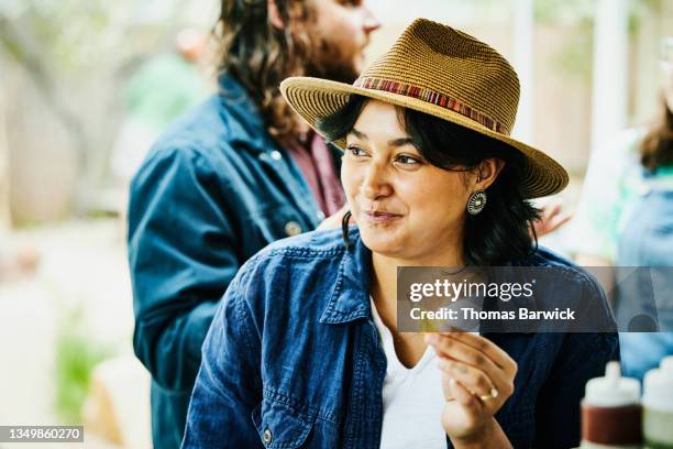 medium shot portrait of smiling woman eating at food truck with friends - indian food bildbanksfoton och bilder