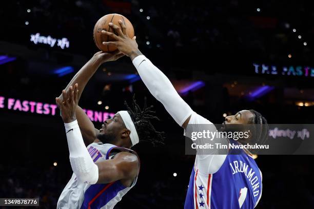 Andre Drummond of the Philadelphia 76ers blocks the shot of Jerami Grant of the Detroit Pistons during the third quarter at Wells Fargo Center on...