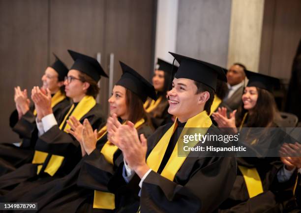 happy graduates applauding in their graduation ceremony - graduation speech stock pictures, royalty-free photos & images