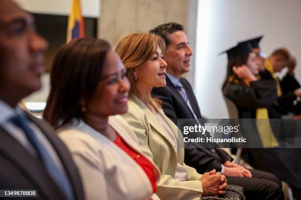 proud parents looking happy at a graduation ceremony - alumni stock pictures, royalty-free photos & images