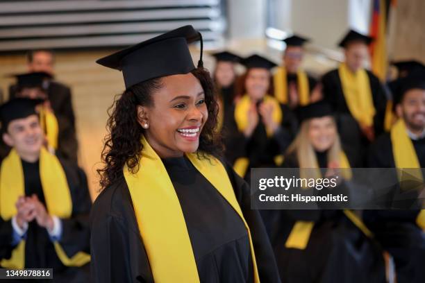 happy graduating student walking to the front to get her diploma - receiving diploma stock pictures, royalty-free photos & images