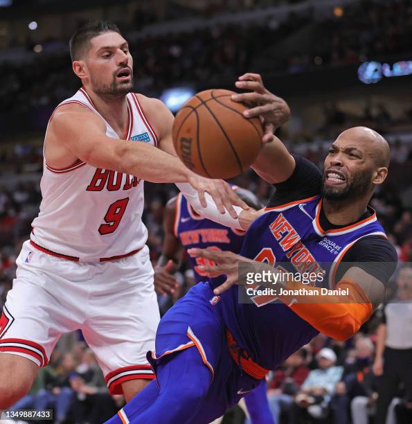 Taj Gibson of the New York Knicks and Nikola Vucevic of the Chicago Bulls battle for a loose ball at the United Center on October 28, 2021 in...
