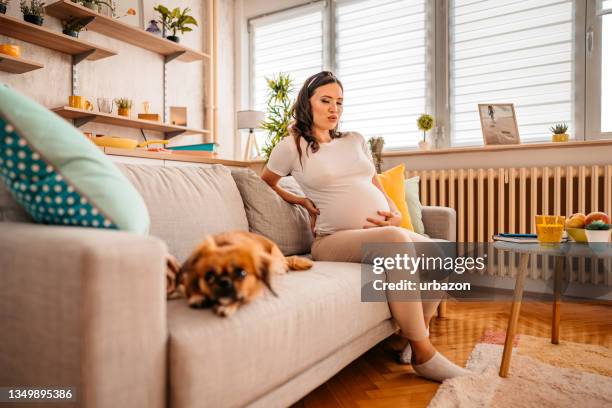 young pregnant woman suffering from backache - muscular contraction stock pictures, royalty-free photos & images