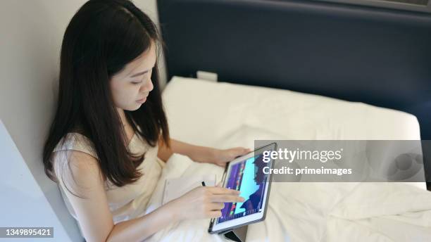 businessperson using mobile online trading with ticker and bid - offer  by fundamental analysis and financial graph in stockmarket forex cryptocurrency and commodity - bid offer stock pictures, royalty-free photos & images