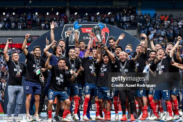 Stefan Medina and Neder Hernándz of Monterrey lift the trophy after their team's victory in the final match of CONCACAF Champions League 2021 between...