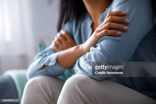 unrecognizable woman hugging herself to comfort while sad - unrecognizable person 個照片及圖片檔