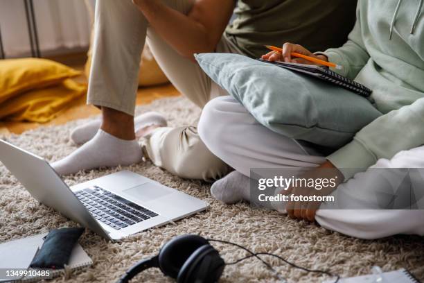 couple learning about stock market investments while watching a video on laptop - stock market floor stock pictures, royalty-free photos & images