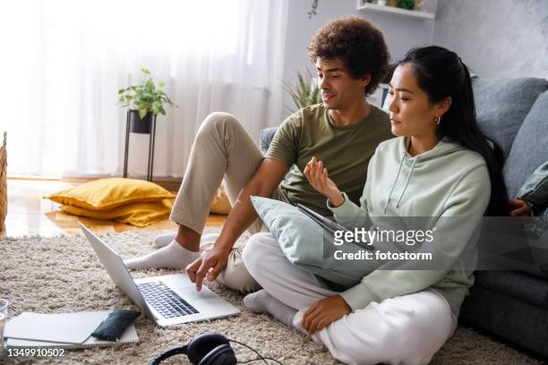 couple watching a video on investing in stock market and having discussions - stock exchange floor stock pictures, royalty-free photos & images