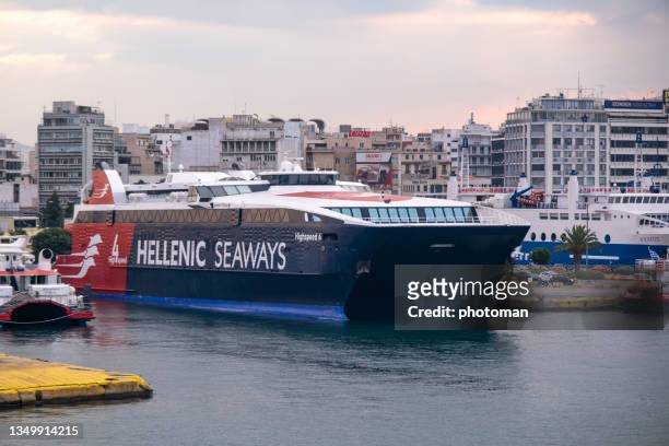 front view on majestic hellenic seaways catamaran docking in front of city - greece message stock pictures, royalty-free photos & images